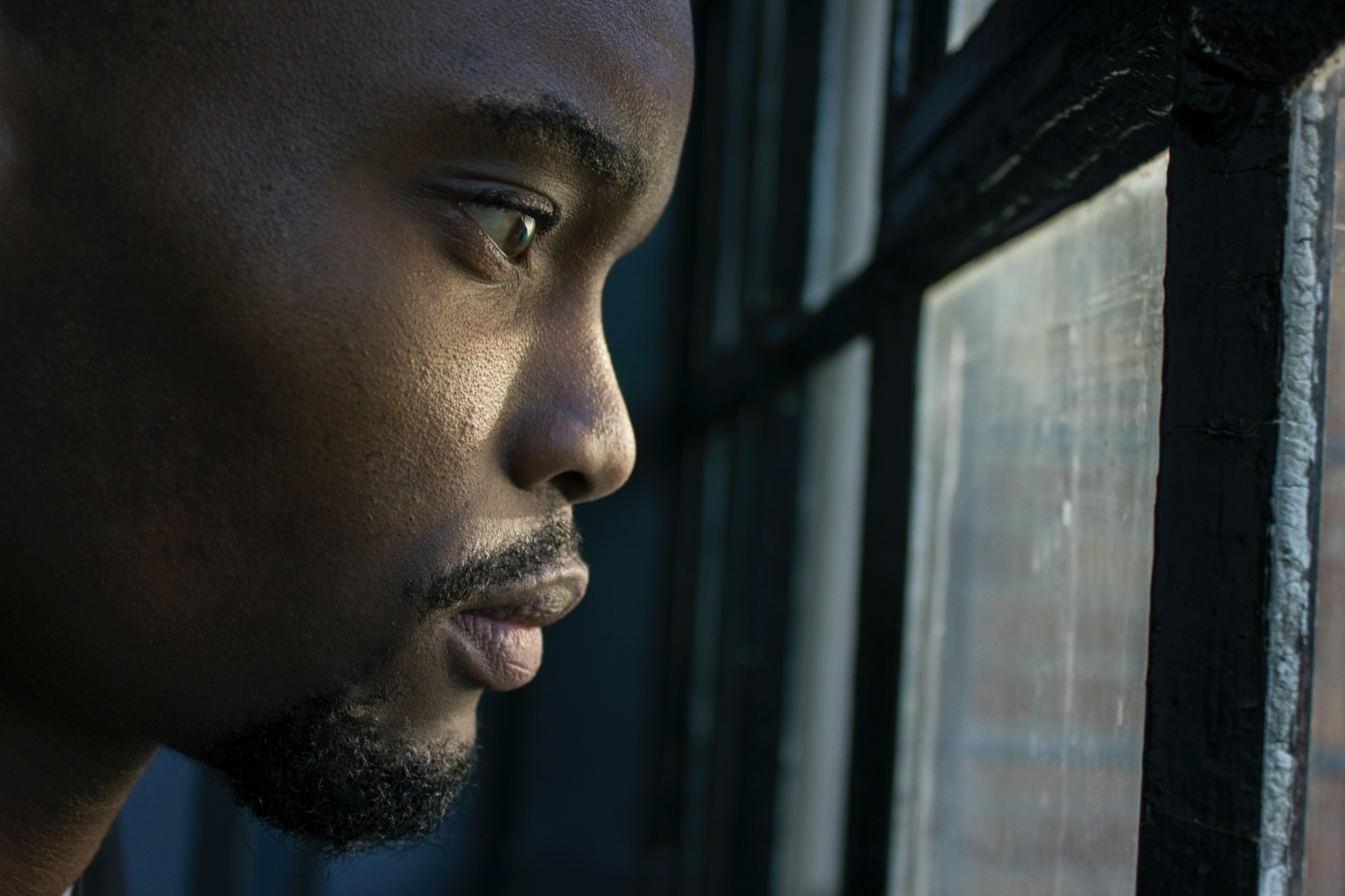 Man looking outside through the window