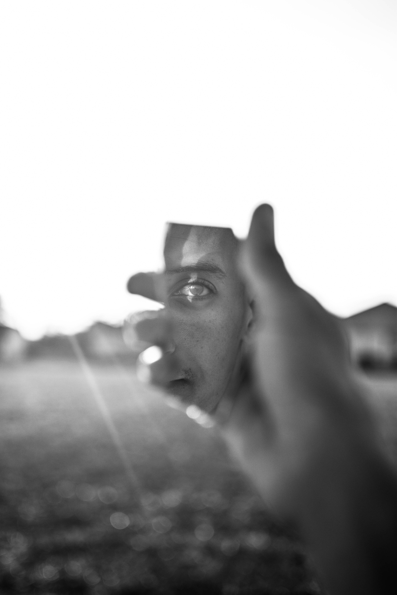 Black and White picture of a person looking at himself on a mirrror