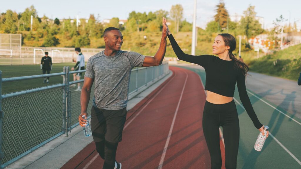 Couple Exercising in the Running Track