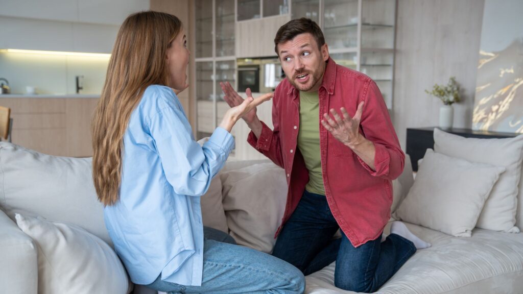 Annoyed husband narcissist raising voice at wife, reproaching, shouting at defensive woman