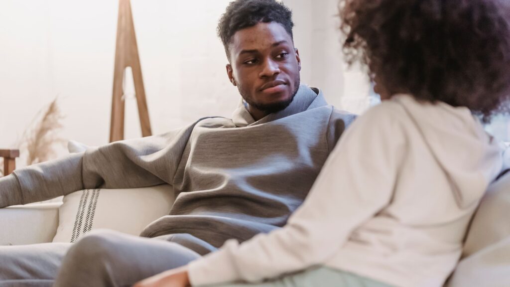 Black couple in casual clothes resting and talking